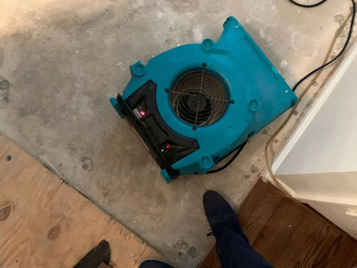 Air mover drying subfloor during Commercial Water Damage Restoration in Sandy Springs